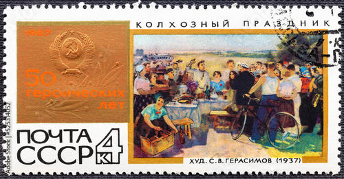 USSR - CIRCA 1967: A postage stamp printed in the USSR shows picture Collective-farm holiday . devoted 50 heroic years. photo