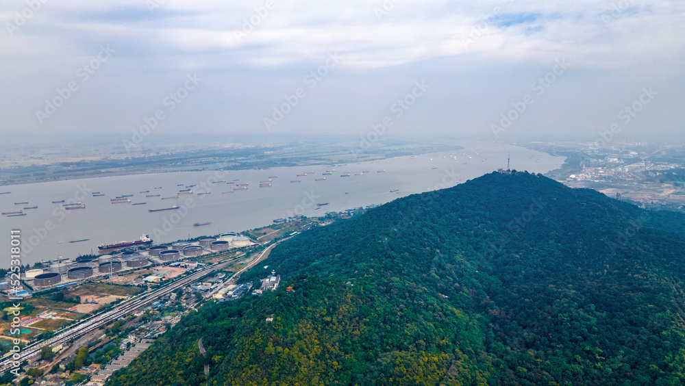 Aerial photography of smog and industrial pollution shrouded in Qixia Mountain, the Yangtze River and busy transport ships in Nanjing City, Jiangsu Province, China