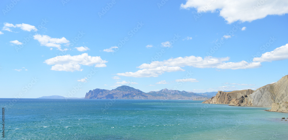 Capri Crimea, blue sky with clouds, sea and mountains in the distance
