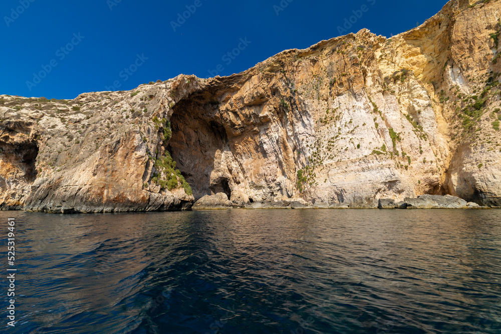 The Blue Grotto is a complex of sea caves along the Southeastern part of Malta, and on sunny days, the reflection of sunlight on the white sandy seafloor lights up the caves in bright blue hues