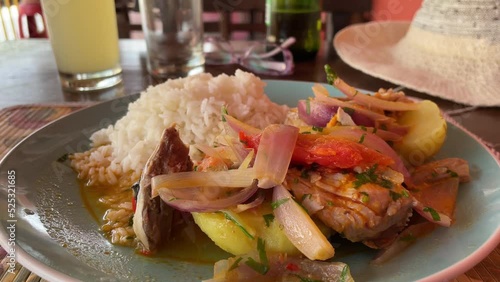 sudado de pescado traditional peruvian food in cafe, seafood plate on the table
