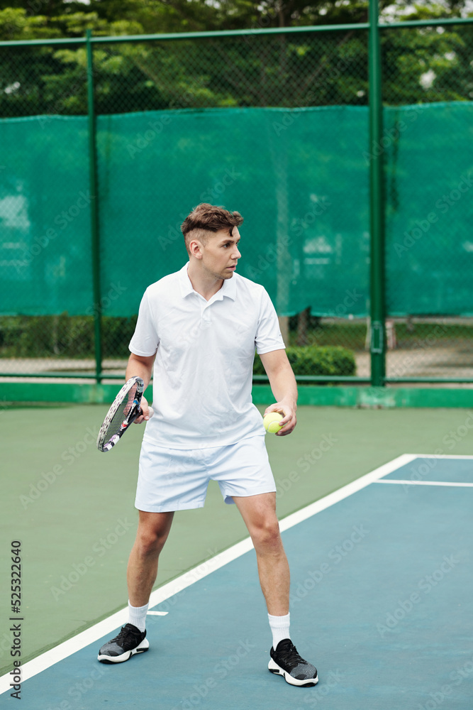 Tennis Player Serving Ball