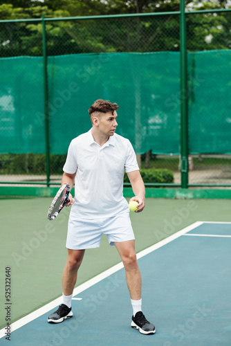 Tennis Player Serving Ball © DragonImages