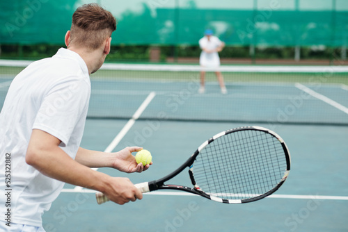 Man Playing Tennis with Friend © DragonImages