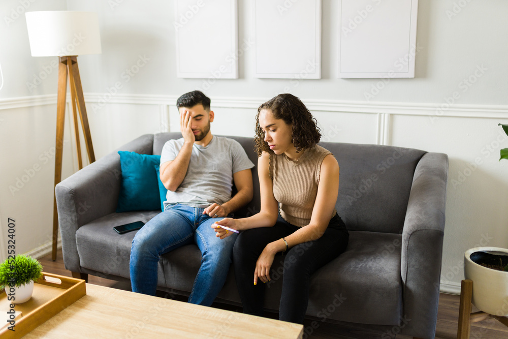 Depressed couple looking at a negative pregnancy test Depressed couple looking at a negative pregnancy test
