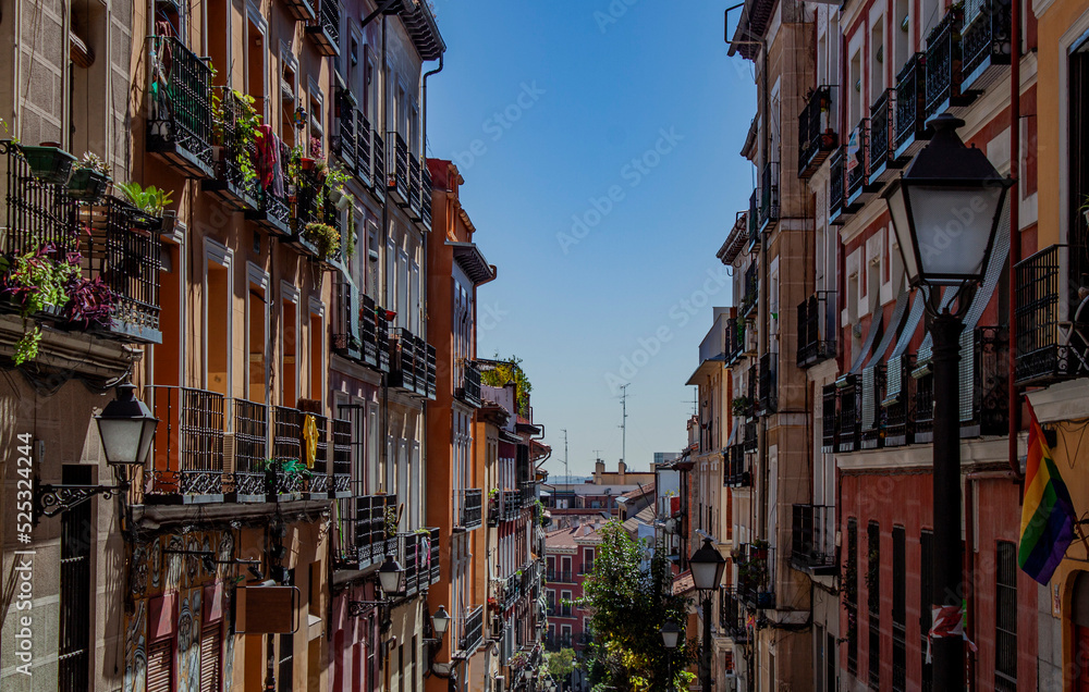 Exterior view of beautiful historical buildings in Madrid, Spain, Europe. Colorful Mediterranean urban street in the former Jewish quarter, Lavapiés, Embajadores neighborhood of the Spanish capital.