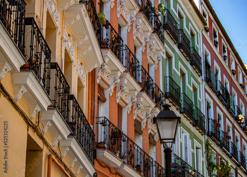 Exterior view of beautiful historical buildings in Madrid, Spain, Europe. Colorful Mediterranean urban street in the former Jewish quarter, Lavapiés, Embajadores neighborhood of the Spanish capital.
