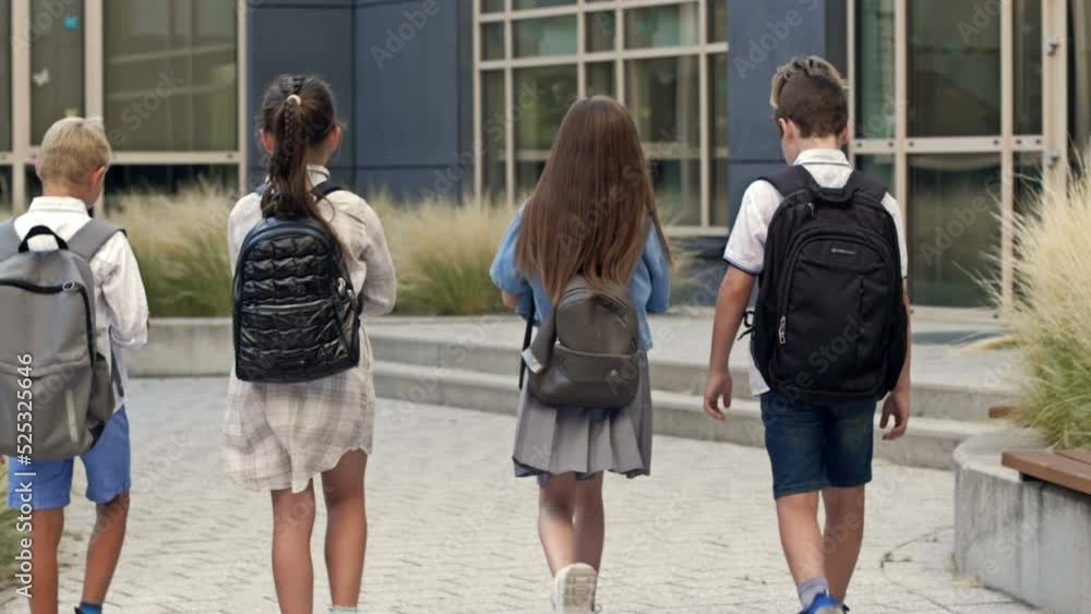 Group of elementary school students rush to a lesson to school. Back to school.