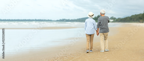 Asian Lifestyle senior couple walking chill on the beach happy in love romantic and relax time after retirement.  People tourism elderly family travel leisure and activity after retirement vacations 