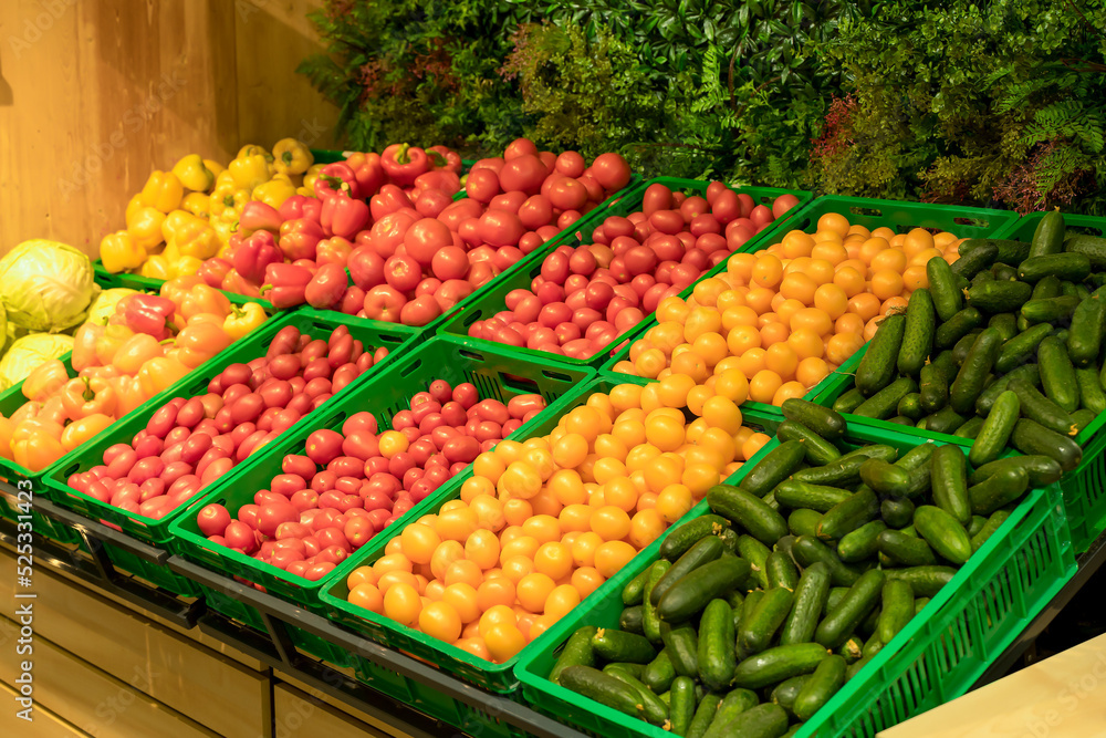 Supermarket vegetables background. Fresh tomatoes and peppers in boxes on the supermarket counter. Food, grocery, agriculture concept