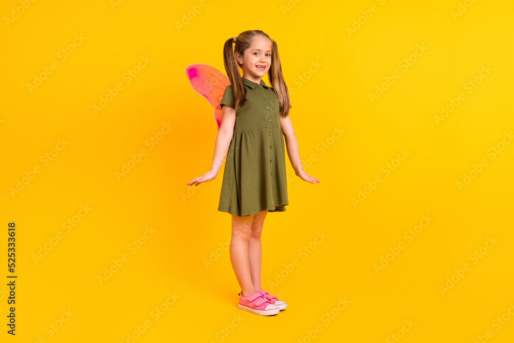 Full length photo of cheerful satisfied girl wear butterfly wings costume isolated on yellow color background
