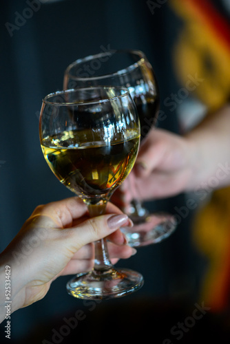 glasses of red and white wine in female hands 