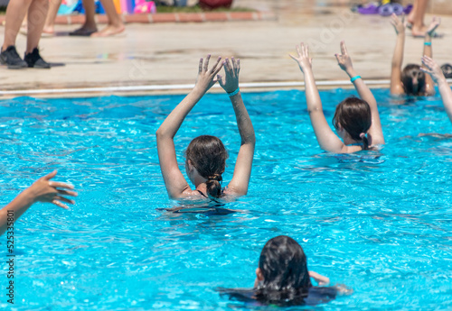 Women do exercises in the blue pool.