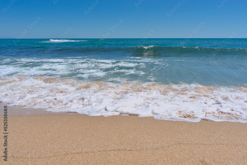 Clear emerald green sea with white foam and clean sandy beach Clear emerald green sea with white foam and clean sandy beach