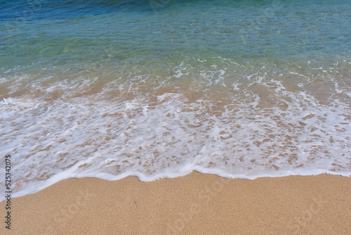 Clear emerald green sea with white foam