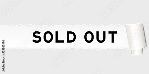 Ripped gray paper background that have word sold out under torn part