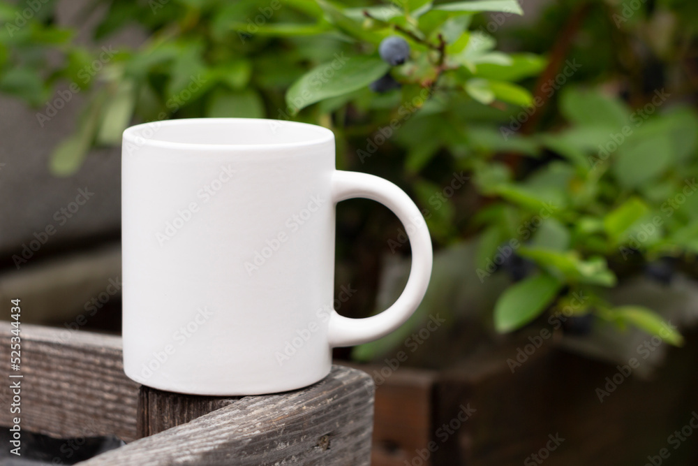 White mug in the garden.