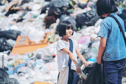 Poor children collecting garbage for sale Concept of pollution and Environment recycling old waste World Environment Day photo