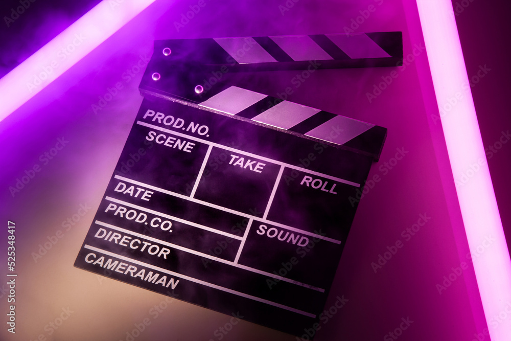 Clapperboard movie slate on Glowing neon lighting background. video director making cinema film. Film clapper design element. filmmaker clapperboard to make video film