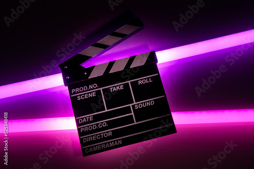 Clapperboard movie slate on Glowing neon lighting background. video director making cinema film. Film clapper design element. filmmaker clapperboard to make video film