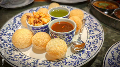Pani Puri, Golgappe, Indian Food Snacks from the plate. Indian evening street food. Pani Puri or Puchka Water Balls
