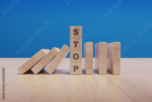 Stop text made with wooden blocks on a table photo