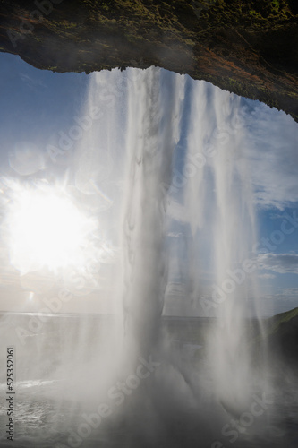 Behind the waterfall with the sun 