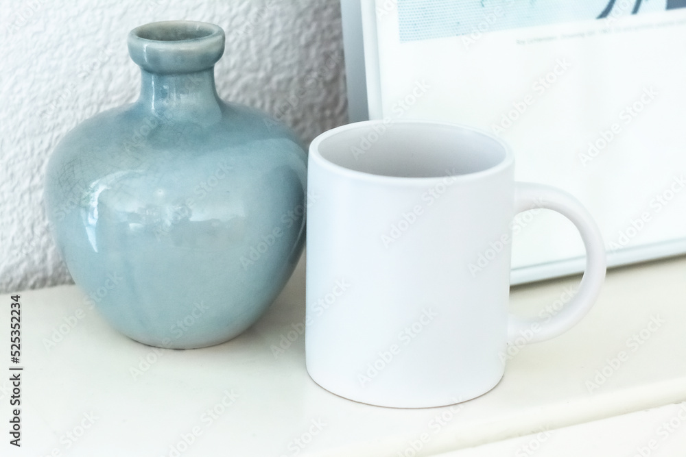White mug on shelf. Artwork space