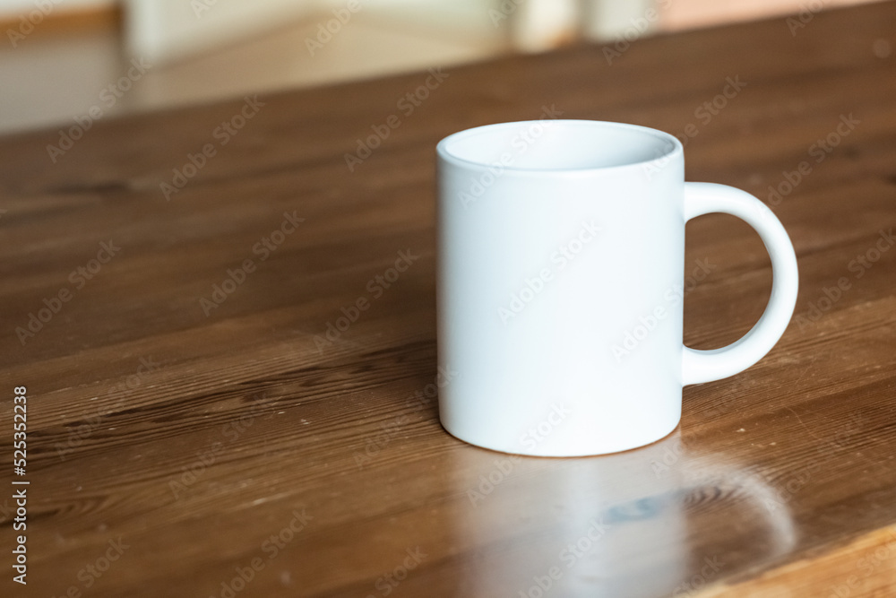 White mug on the wooden table.