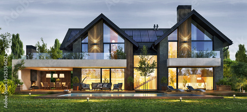 Evening view of a large modern house with solar panels on the roof