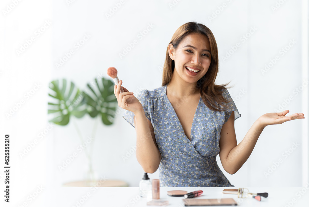 Beautiful asian woman blogger is showing how to make up and use cosmetics. In front of the camera to recording vlog video live streaming at home.Business online influencer on social media concept. Beautiful asian woman blogger is showing how to make up and use cosmetics. In front of the camera to recording vlog video live streaming at home.Business online influencer on social media concept.