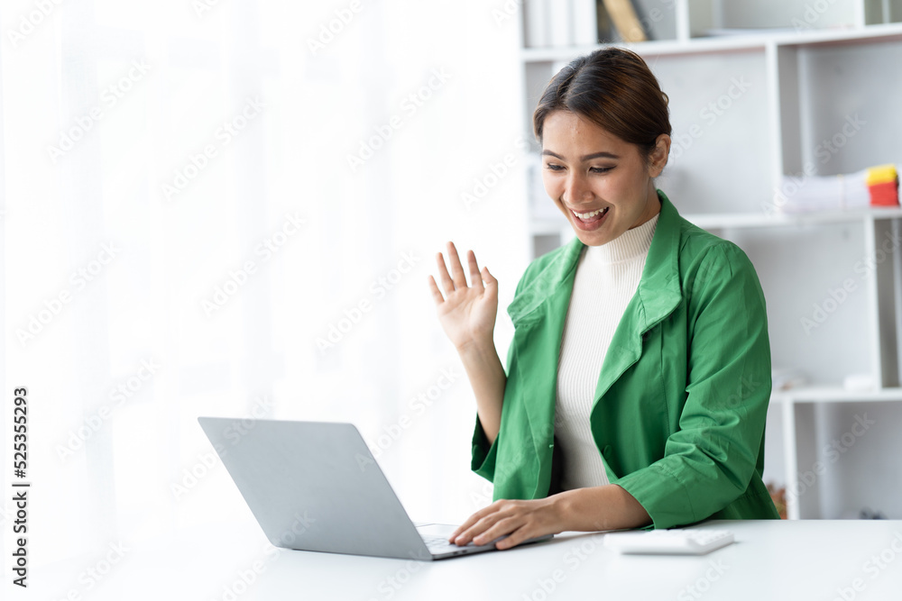 Asian woman working with laptop in her office. business financial concept. Asian woman working with laptop in her office. business financial concept.