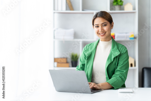 Asian woman working with laptop in her office. business financial concept. © PaeGAG