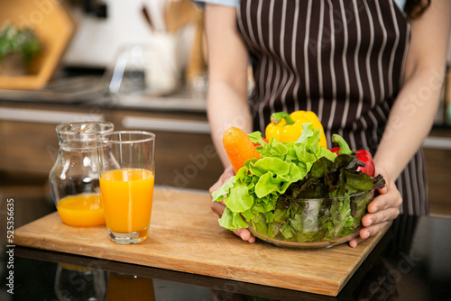 The  picture of varieties of vegetables and fruits are in the glass bowl and orange juice. Healthy food concept.