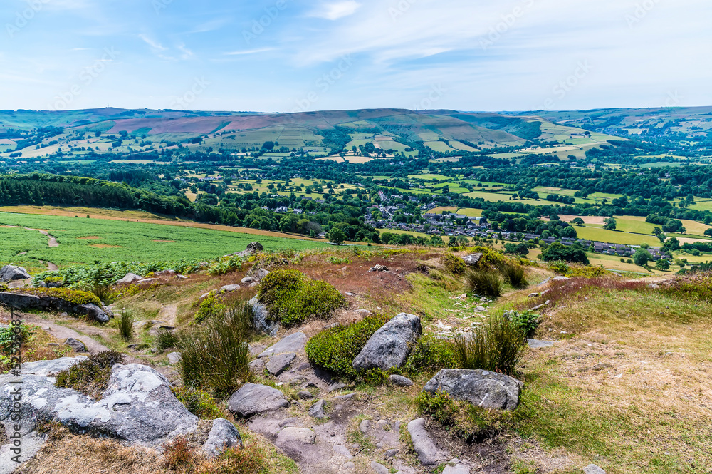 A view down from the Bamford Edge escarpment towards Bamford town in summertime A view down from the Bamford Edge escarpment towards Bamford town in summertime