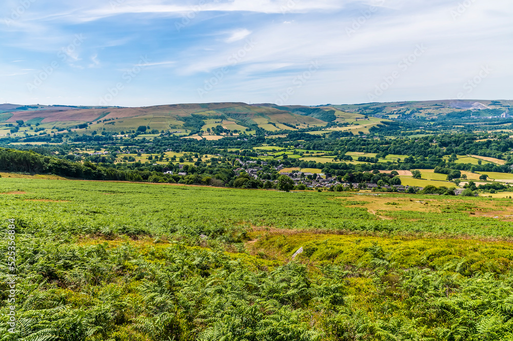 A view from the lower reaches of Bamford Edge towards Bamford town in summertime