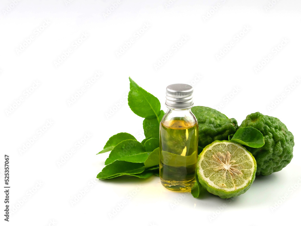Fresh green kaffir lime herb with essential oil bottle, isolated on white background. Fresh green kaffir lime herb with essential oil bottle, isolated on white background.