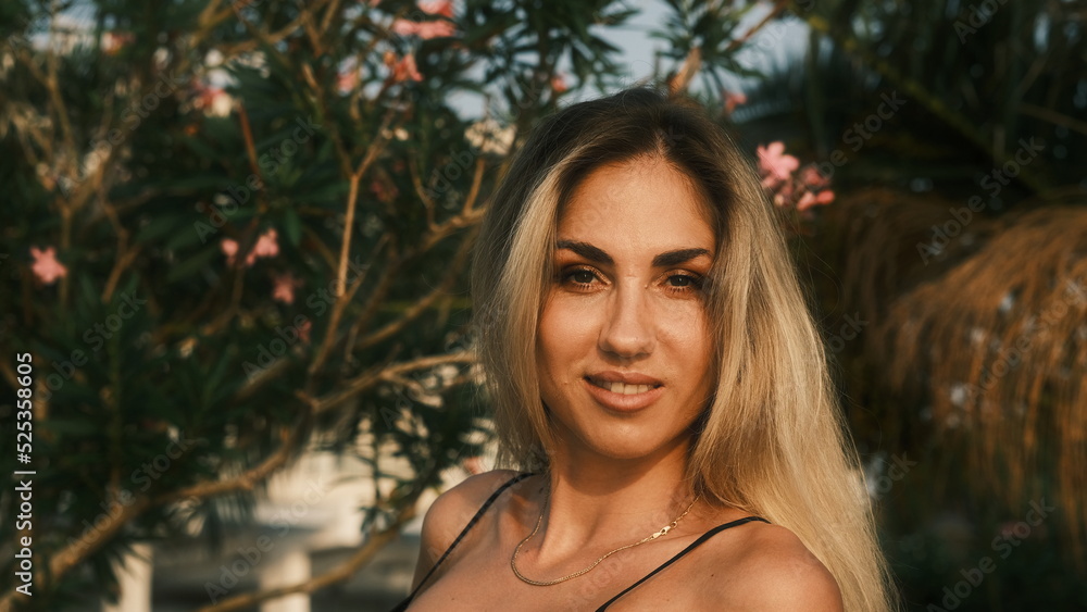 Beautiful model posing in sunset sunlight in the park Beautiful model posing in sunset sunlight in the park