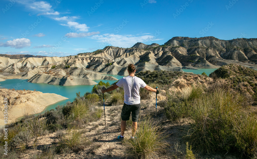 hiker man looking at beautiful turquoise lake and mountain- Andalusia