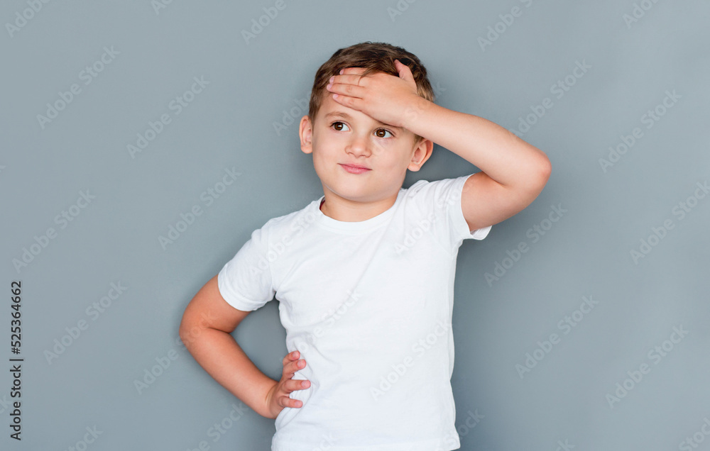 childhood, expressions and people concept - little boy in white t-shirt facepalming over grey background childhood, expressions and people concept - little boy in white t-shirt facepalming over grey background