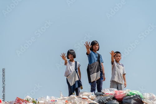 Poor children collecting garbage for sale Concept of pollution and Environment recycling old waste World Environment Day photo