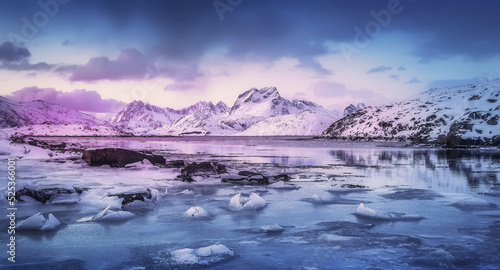 Beautiful winter landscapes in Lofoten islands, Northern Norway. wintry season. Amazing winter nature scenery. Fantastic colorful sunset over north fjord above snow covered mountains. Norway © jenyateua