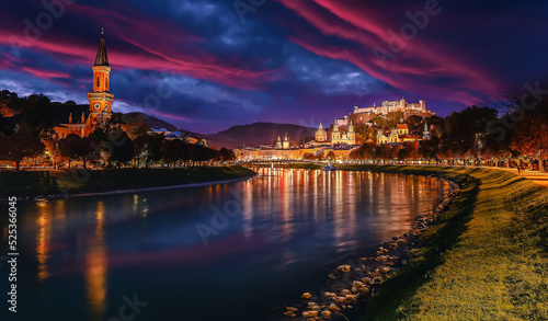 Wonderful evening scene of Salzburg city. View of the historical city, famous Hohensalzburg Fortress with reflection in the Salzach river, popular travel destination in Austria. Central Europe.