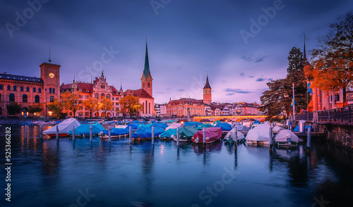 Stunning view of historic Zurich city center with famous Fraumunster and Grossmunster Churches and river Limmat during sunset, Zurich, Switzerland. Popular travel destination