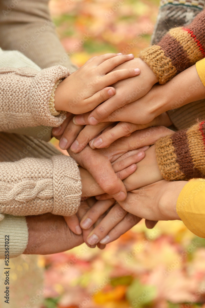 family putting hands together