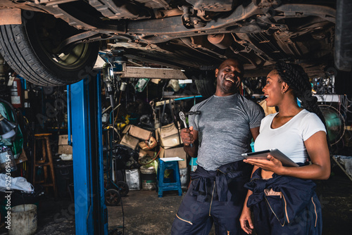 Professional mechanic checking car suspension before delivery.