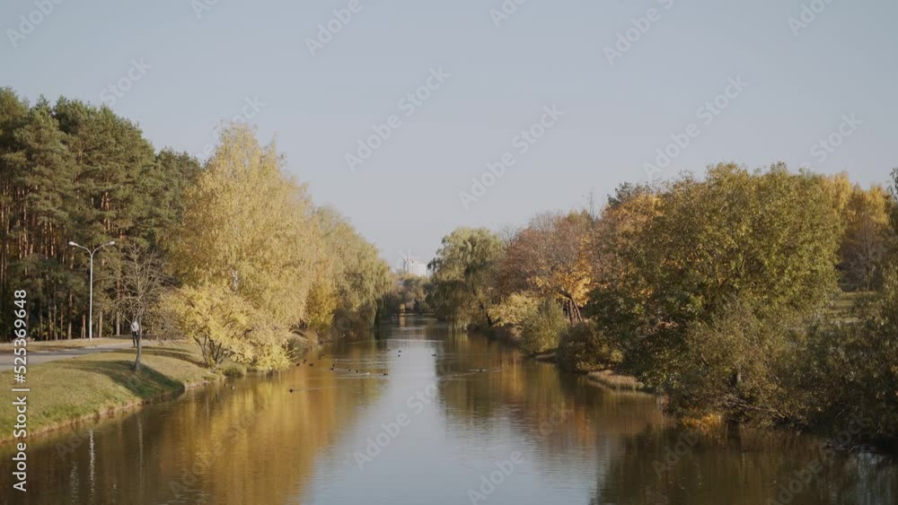 Beautiful view of city autumn park with river on sunny day. Beautiful view of city autumn park with river on sunny day.