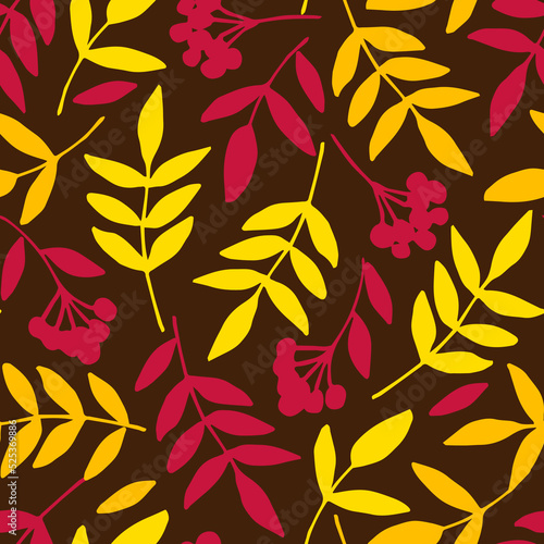 Simple floral vector seamless pattern. Dry yellow leaves, branches, rowan berries on a dark brown background. For fabric prints, textiles. Autumn-summer collection. Seasonal leaf fall.
