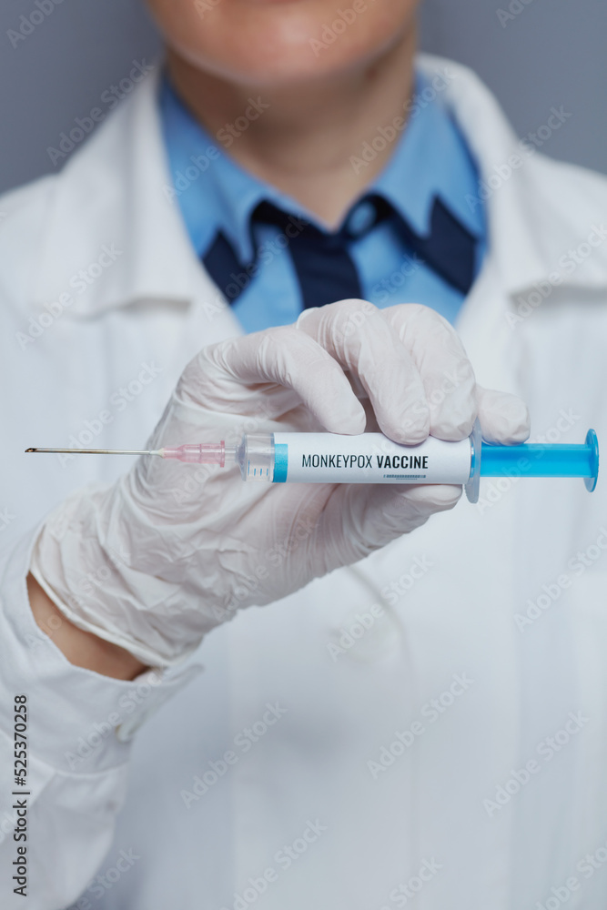 Closeup on modern female medical doctor against grey background Closeup on modern female medical doctor against grey background
