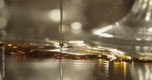 Syrup or honey dripping on a mirror surface